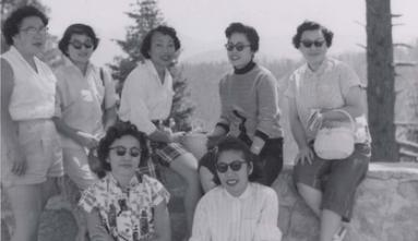 the atomettes group of women pose for a photo under trees